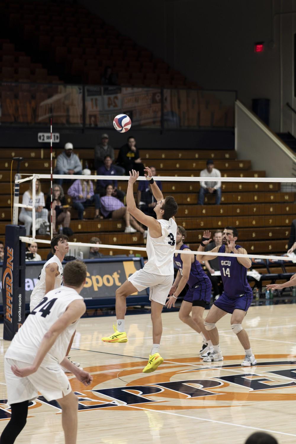 Graduate setter Gabe Dyer sets the ball for his teammate against Grand Canyon University on Feb. 27 at Firestone Fieldhouse. The Waves have 540 assists over 13 games this season.