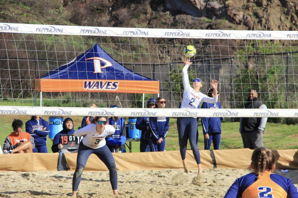 Redshirt junior Emma Bubelis serves in a match against the University of Texas at El Paso on March 15 at the Pepperdine Beach Volleyball Courts. Bubelis and her partner, graduate student Marley Johnson, defeated their opponents in three sets. Photo by Guinevere Hesse