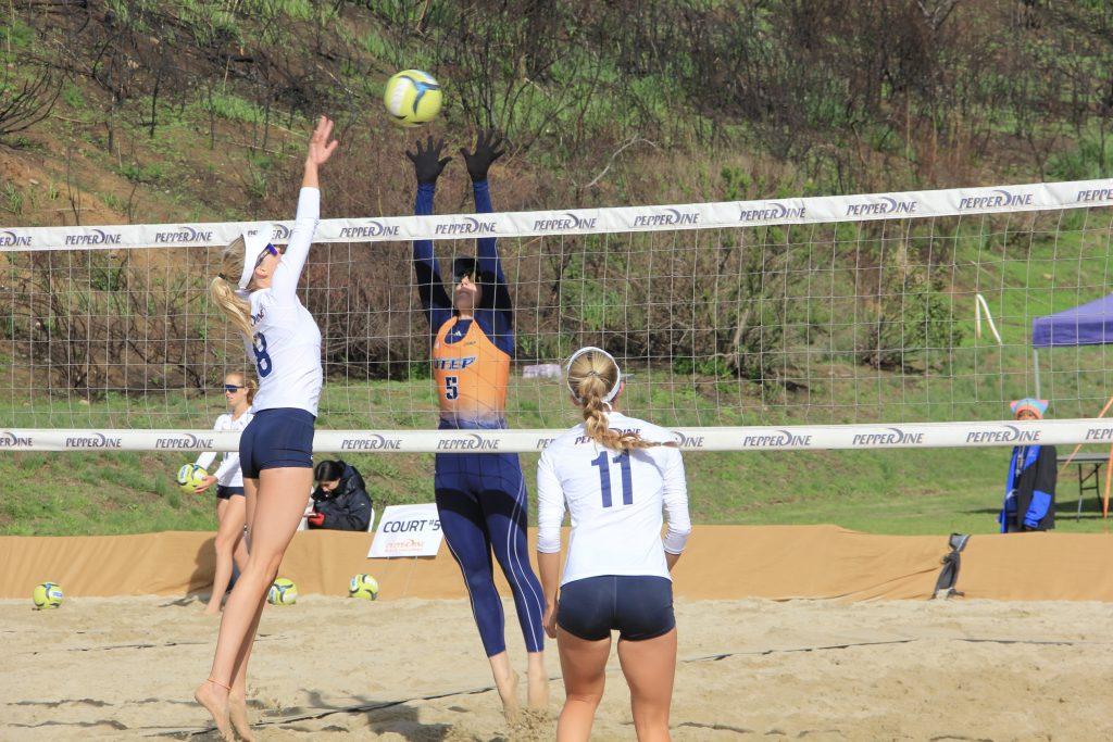 Senior Kate Clermont goes for a block against the University of Texas at El Paso on March 15 at the Pepperdine Beach Volleyball Courts. Clermont and her partner, senior McKenna Thomas, won their three-set match for the final overall point for the Waves. Photo by Guinevere Hesse