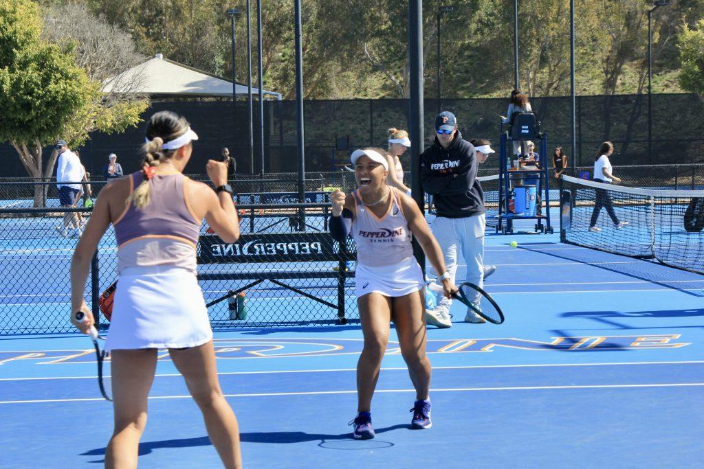 Senior Savannah Broadus cheers after a point with her doubles partner sophomore Vivian Yang during a 5-2 win for the Waves at the Ralphs-Straus Tennis Center against University of California, Berkeley on Feb. 22. The pair is currently ranked No. 8 in the nation for doubles play. Photos by Guinevere Hesse