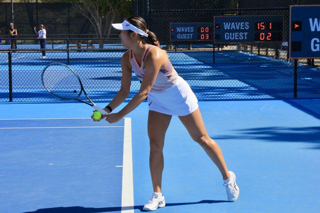 Yang prepares to set the ball in her singles match Feb. 22 against the California Bears at the Ralphs-Straus Tennis Center. Yang lost in her singles match but won with Broadus in her doubles match.