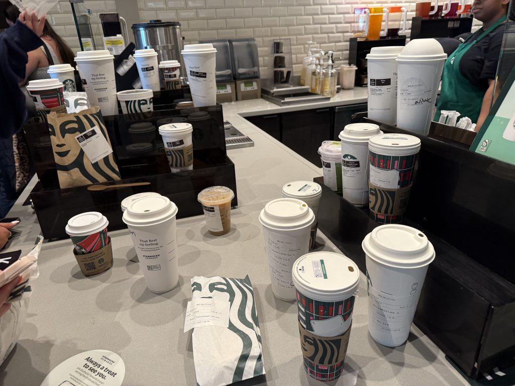 Starbucks orders are prepared and set out for students to grab in Payson Library on March 11. The hot drinks receive flat lids, cold drinks get the original-style hot drink lids and Frappuccinos get a circular lid.