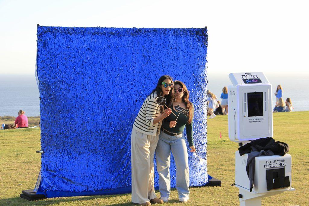 Seniors enjoy using the photo booth to capture memories on Alumni Park on April 7. The photo was one of the various activities offered at Senior Sunset.