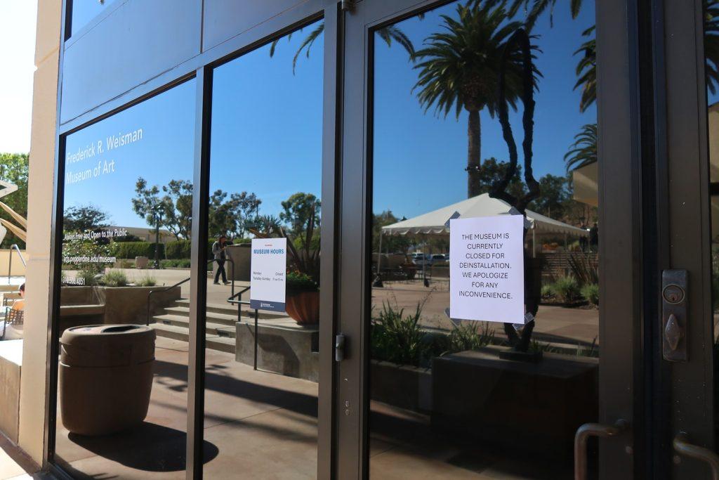 A flyer indicating the Weisman Museum's closure taped to the Museum's front door Oct. 9. The exhibition has yet to be fully deinstalled. Photo by Haylie Ross