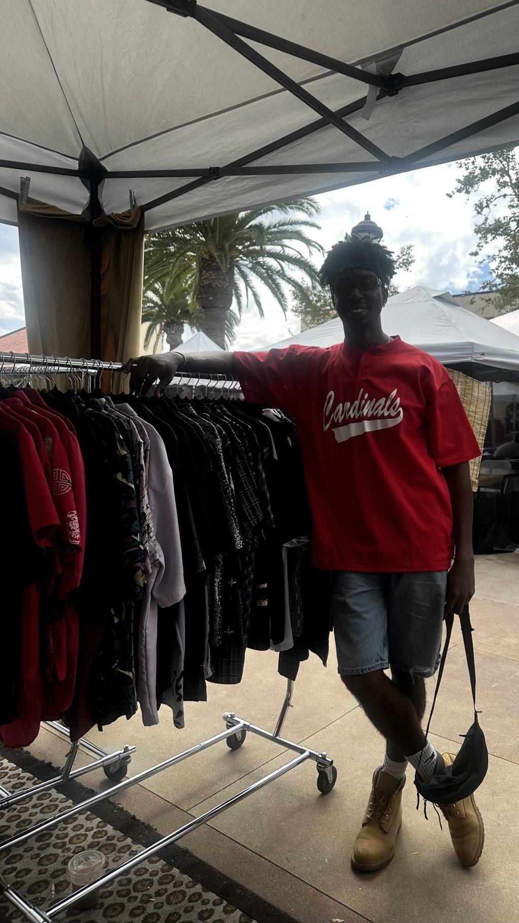Dane Rolins striking a pose against one of his clothing stands for Five Star Vintage.