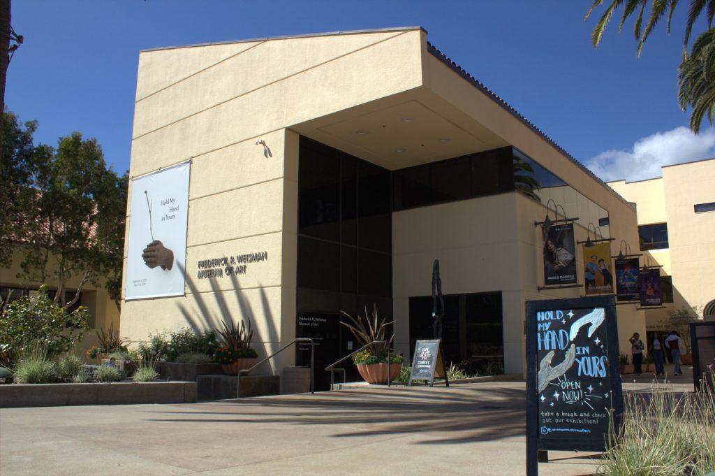 The Frederick R. Weisman Museum of Art on Oct. 3. Signs advertising the "Hold My Hand in Yours" exhibition were placed outside. Photo by Griffin Pilcher