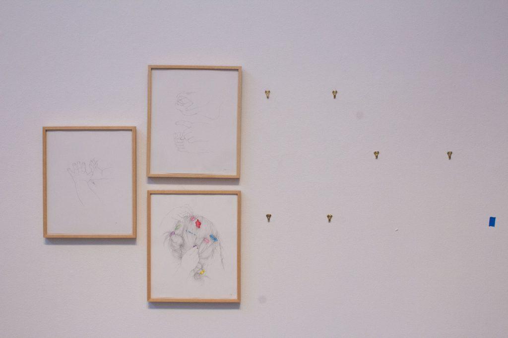 Three out of six drawings by artist Christine Mitchell Adams hang on a wall in Weisman Museum during deinstallation Oct. 8. All six drawings were eventually deinstalled before the art handlers were dismissed for the day. Photo by Griffin Pilcher