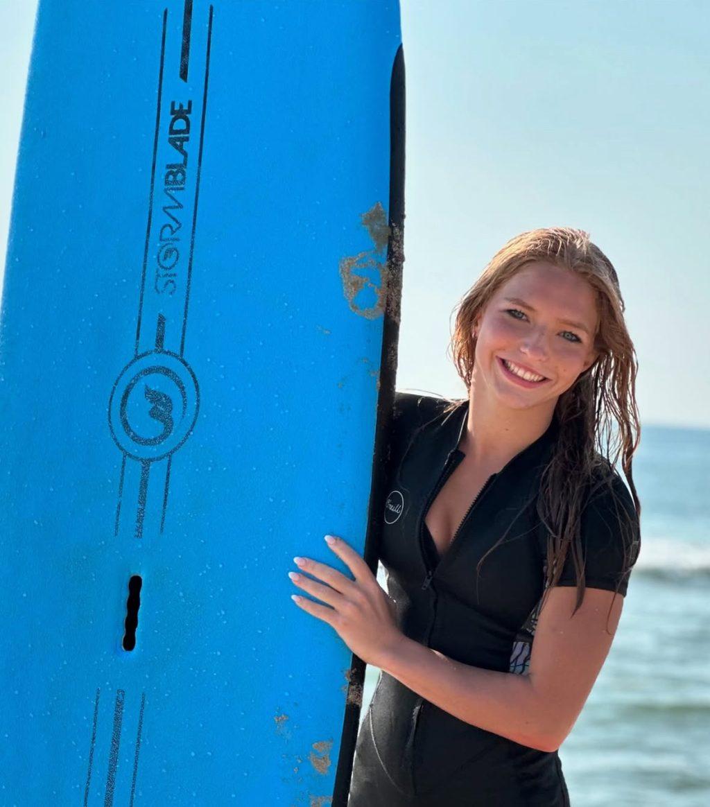 First-year student Faith Kohr smiles while taking a day off to surf and spend time disconnected from social media. Photo courtesy of Faith Kohr