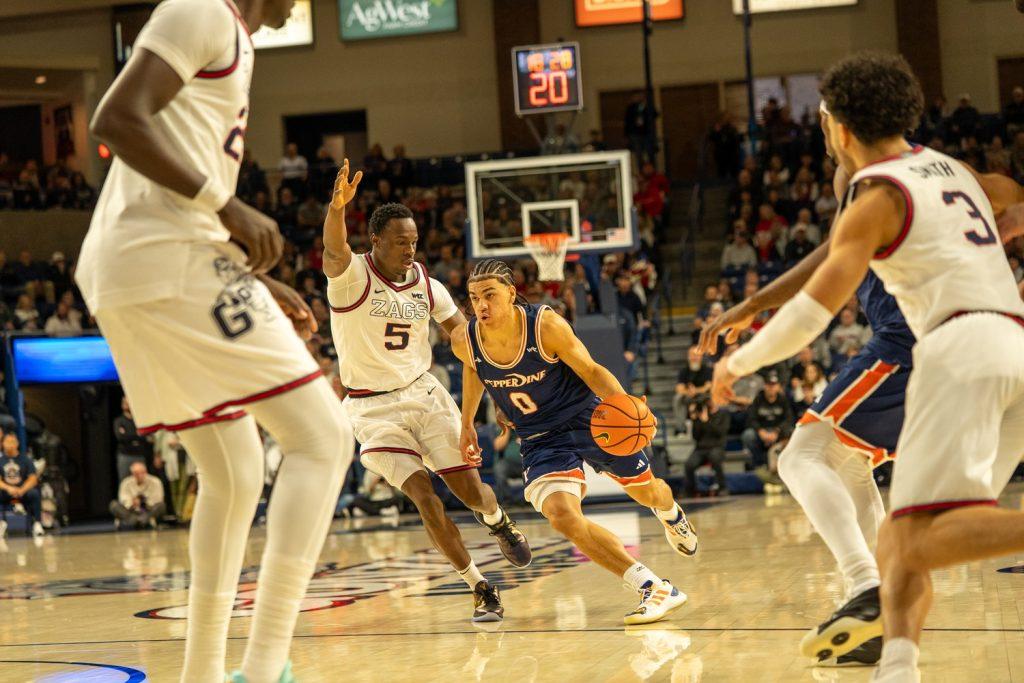 Sophomore guard Styles Phipps beats the Bulldog defender off the dribble and drives into the lane.