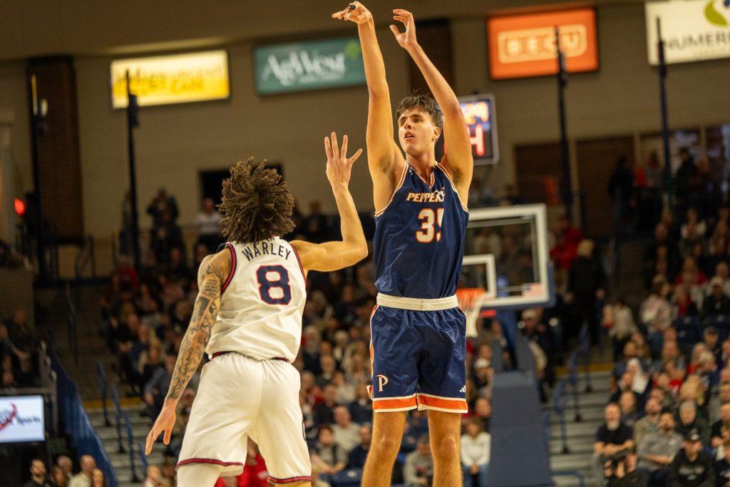 Sophomore center Danilo Dožic rises up for the three in the face of a Gonzaga defender on Jan 21. at McCarthey Athletic Center