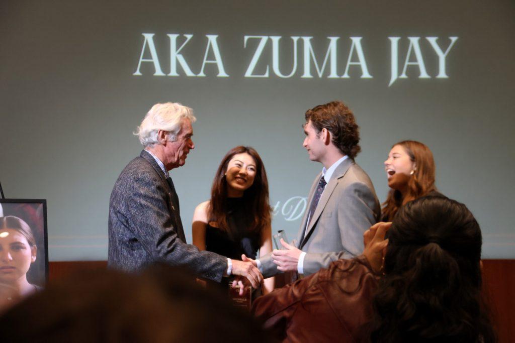 Jefferson Wagner (left) and senior Thomas Breslin (right) accept the award for Best Directing in Smothers Theatre on Feb. 6. Breslin said he learned a lot from Wagner throughout the documentary's production.