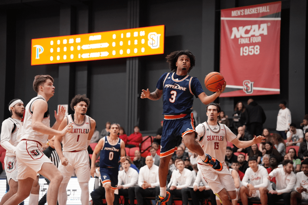 Sophomore guard Aaron Clark beats the Redhawk defenders and elevates in the lane for a layup on Feb. 4 at the Redhawk Center. Clark led the Waves in scoring, finishing with 22 points. Photo courtesy of Pepperdine Athletics.