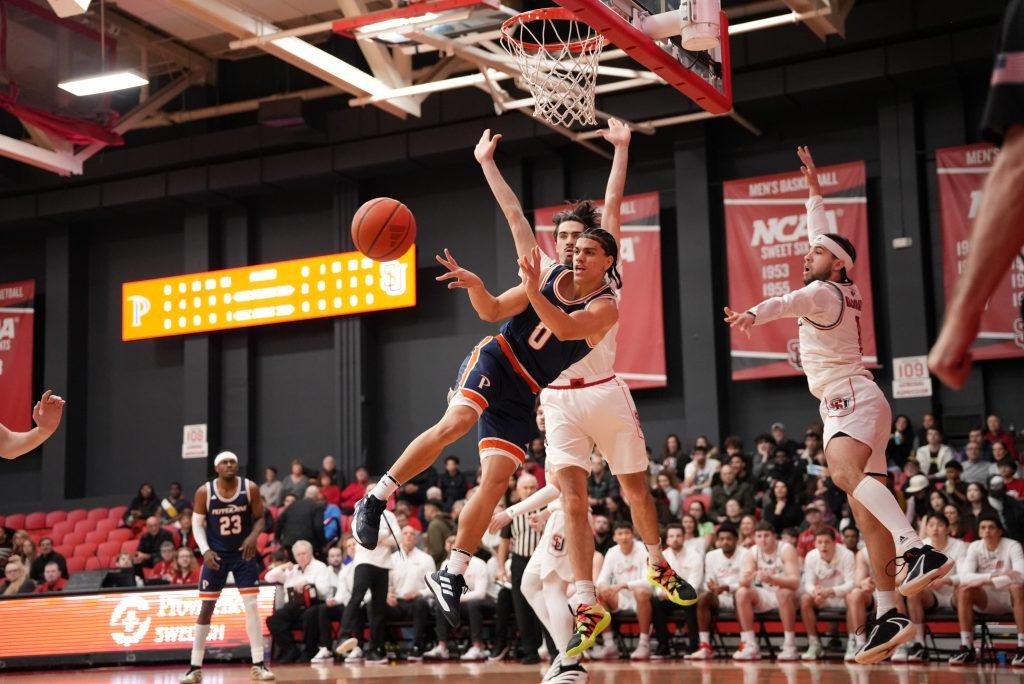 Sophomore guard Styles Phipps weaves through the Seattle defenders and dishes the ball out on Feb 4. at the Redhawk Center. Phipps finished the night with 18 points and seven rebounds. Photo courtesy of Pepperdine Athletics.