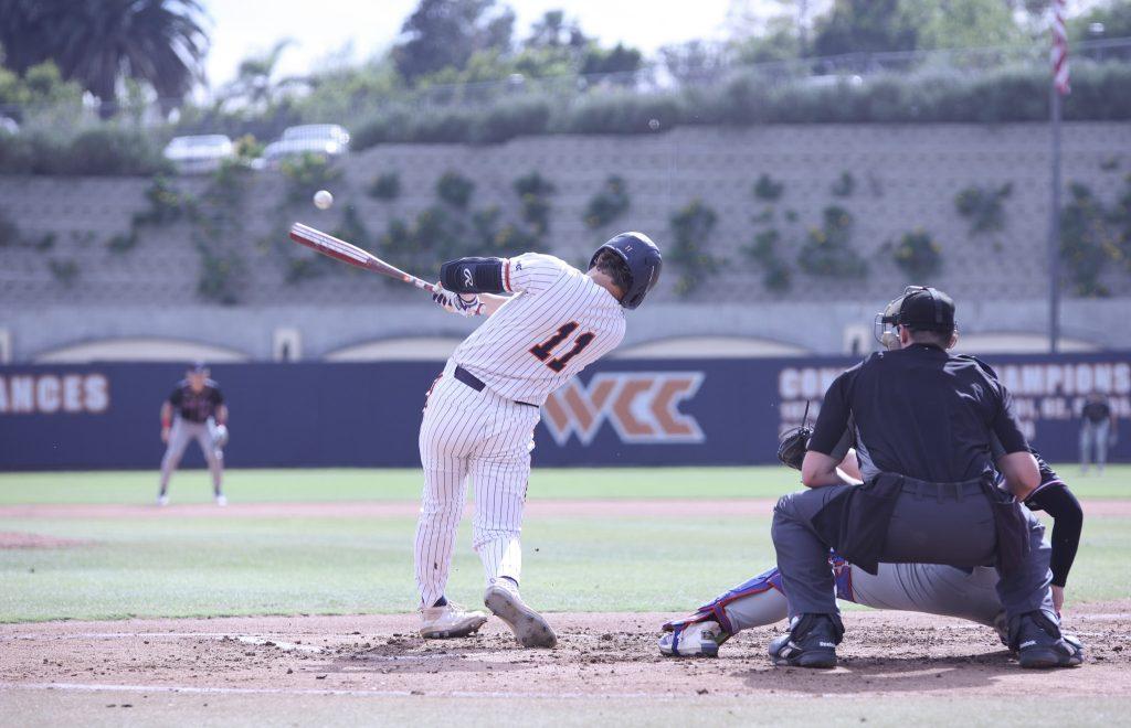 Freshman first baseman James Dell'Amico sends a pitch into the outfield against UMass Lowell on March 13. Dell'Amico finished with seven hits for the weekend.