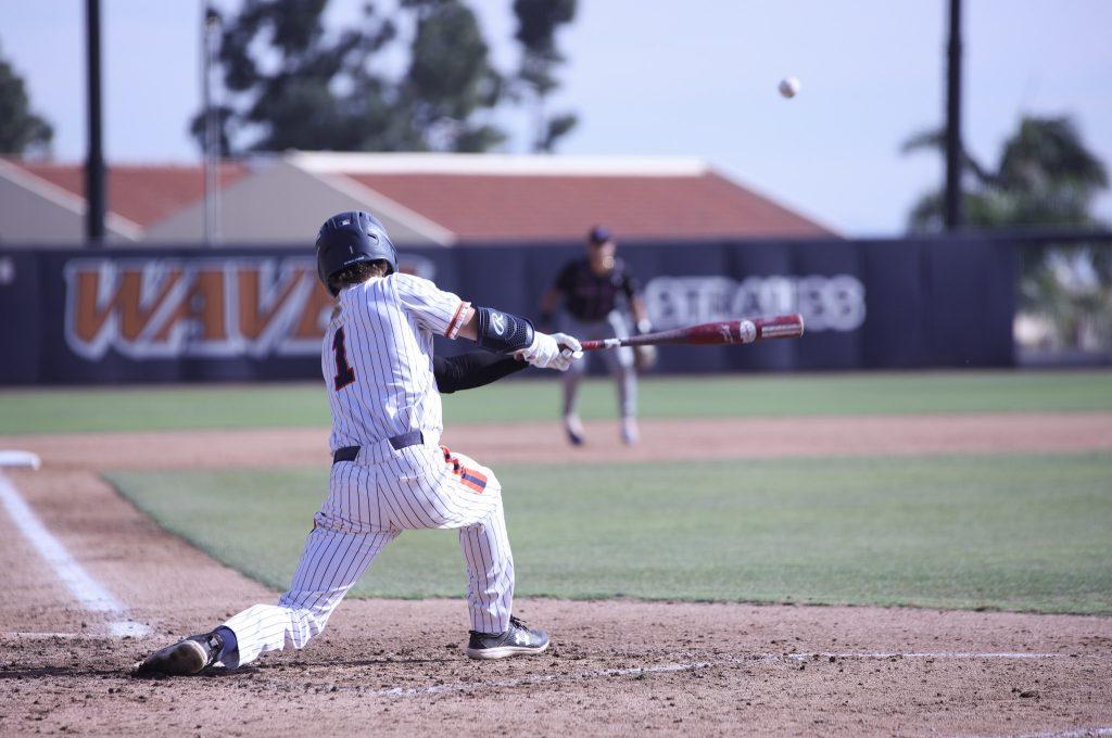 Junior outfielder Dylan Osborne makes contact and slices a pitch to left field against UMass Lowell on March 13. Osborne recorded two hits and one RBI in this game.