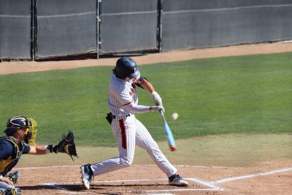 Graduate infielder Daniel Patterson squares up the ball and send it into the outfield against the University of San Diego Toreros on March 28. Patterson is hitting .302 and leads the team in home runs with eight.