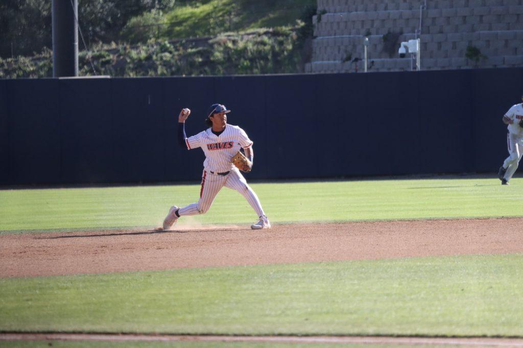 Graduate infielder Julian Nunez fields the ball and preps to fire toward first base against the University of San Diego Toreros on March 28. Nunez leads the team in on-base-percentage at .391.